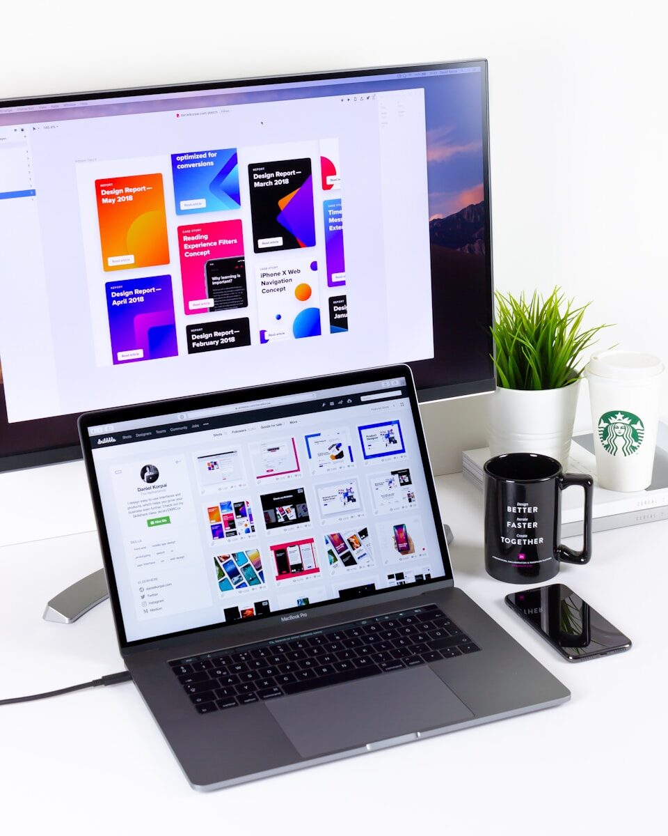 black and gray laptop computer beside black mug